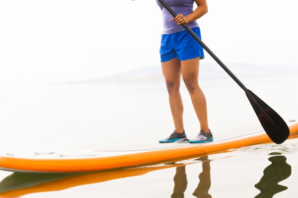 Filipino woman riding paddle board