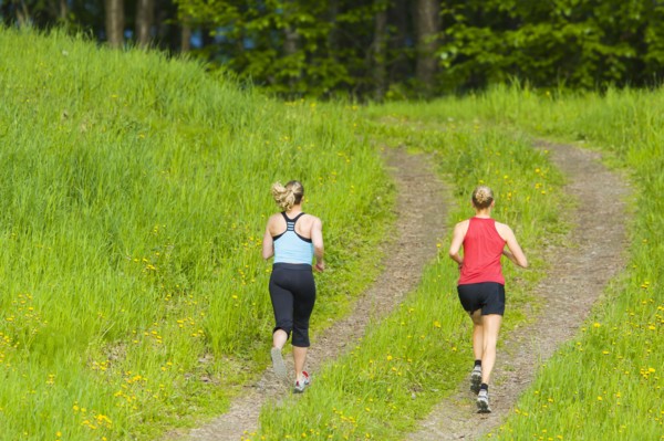 Caucasian women running on path