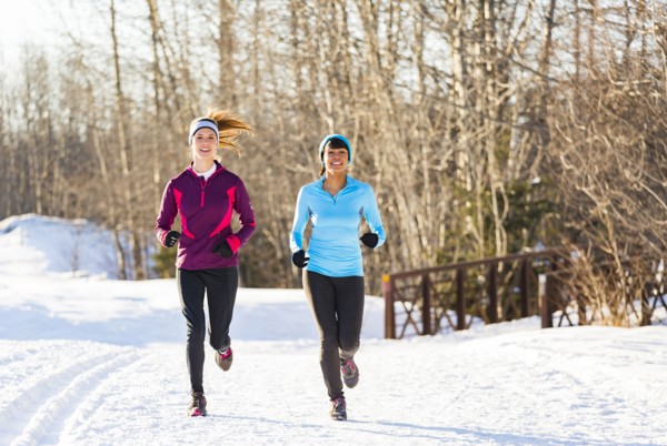 Women running on snow in winter
