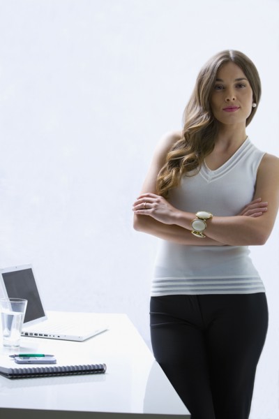 Mixed race businesswoman standing at desk
