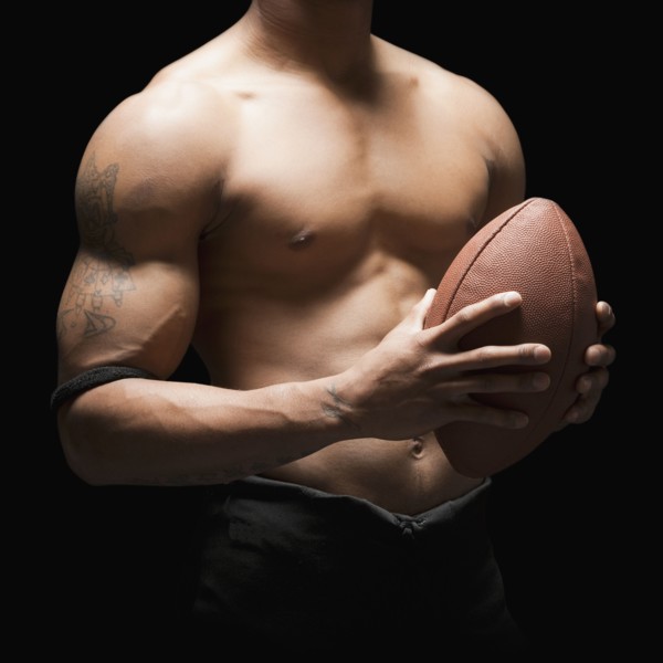 Midsection of bare chested football player