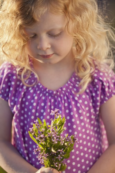 Caucasian girl picking flowers