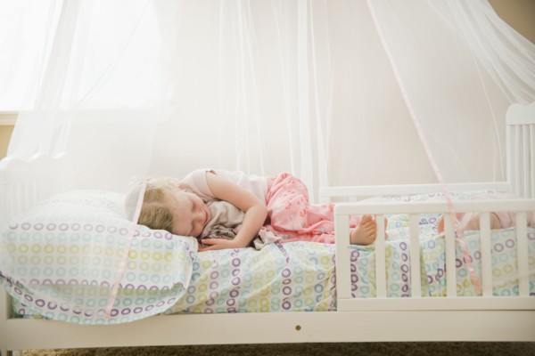 Caucasian girl sleeping in bed