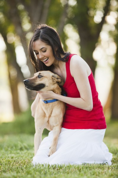 Caucasian woman petting dog