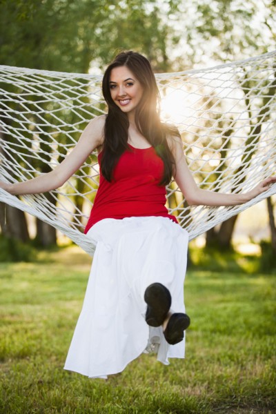 Caucasian woman sitting in hammock