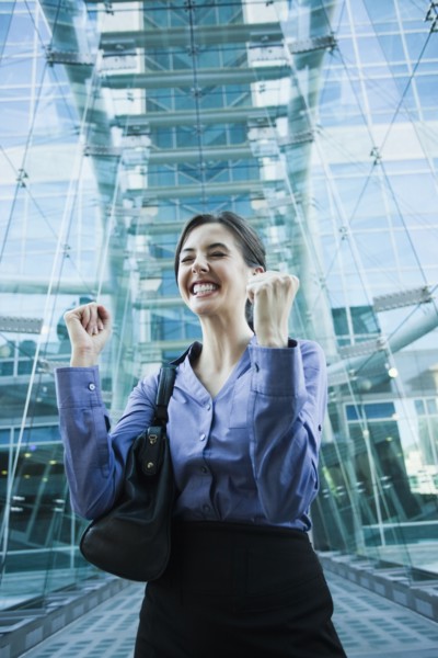 Caucasian businesswoman cheering outdoors