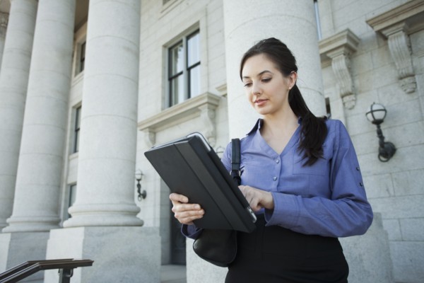 Caucasian businesswoman using digital tablet outdoors