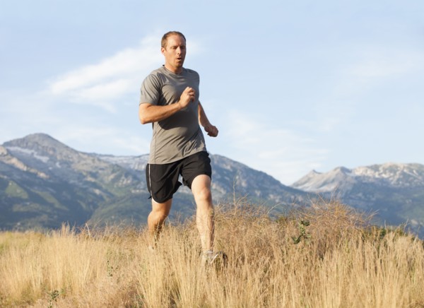 Caucasian man running in remote area