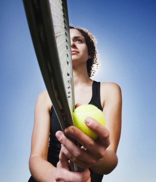 Caucasian woman playing tennis