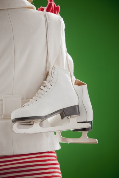 Mixed race woman carrying ice skates