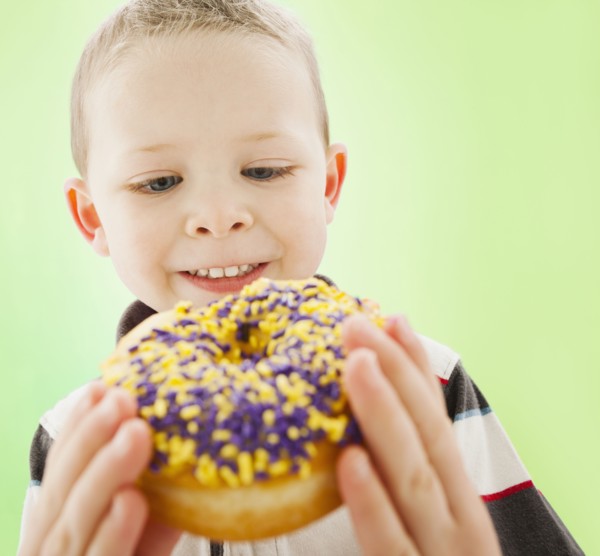 Caucasian boy eating donut