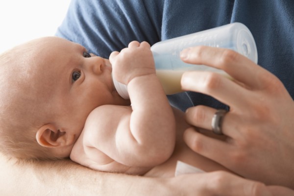 Caucasian father feeding baby girl