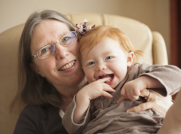 Caucasian grandmother holding granddaughter