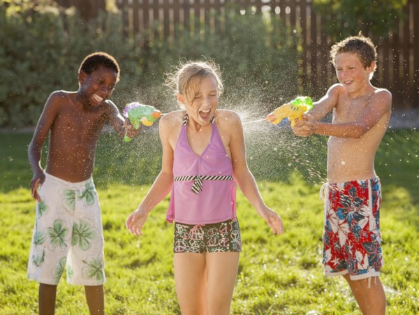 Boys squirting girl with water guns