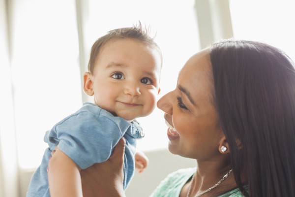 Smiling mother holding son