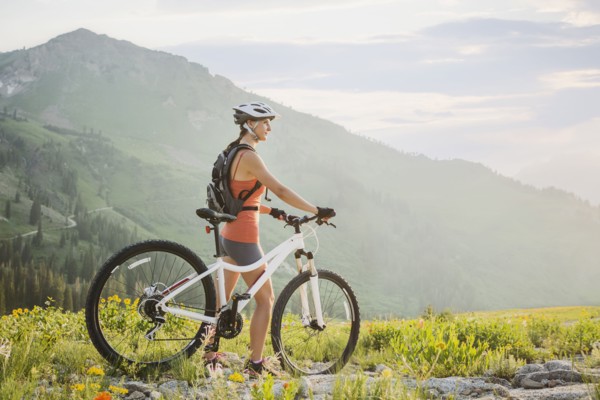 Caucasian woman with mountain bike looking at view
