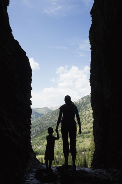 Caucasian mother and son exploring cave