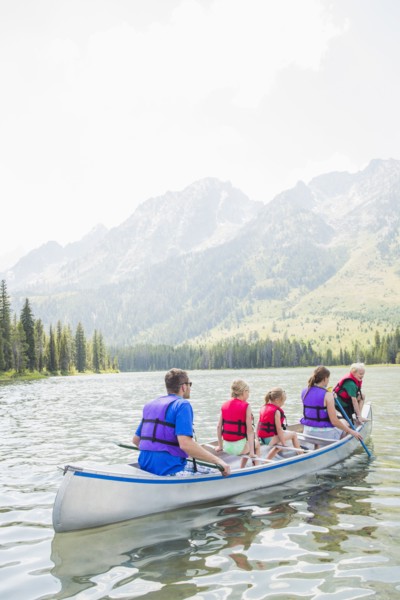 Caucasian family in canoe on lake
