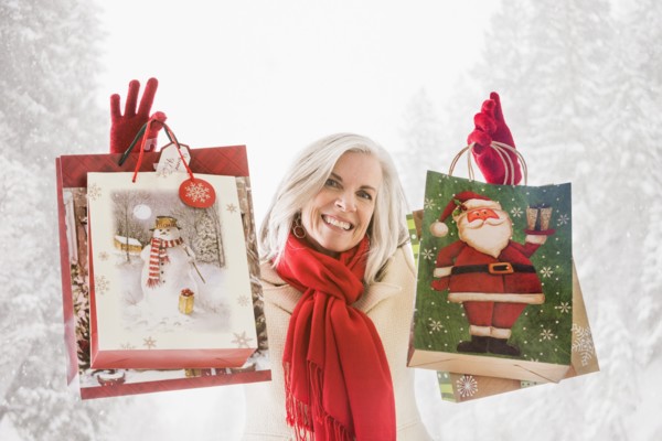 Smiling Caucasian woman with Christmas bags