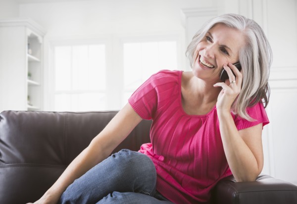Happy Caucasian woman talking on cell phone