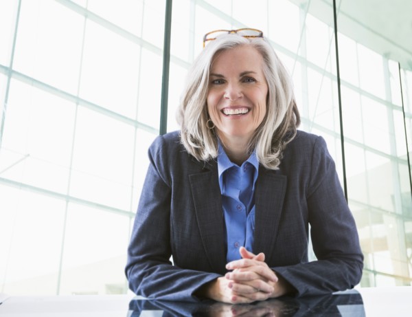 Portrait of confident Caucasian businesswoman at desk