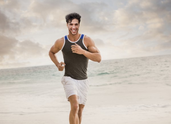 Caucasian man running on beach