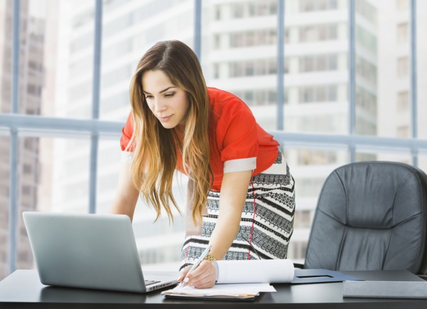 Mixed race businesswoman working at desk