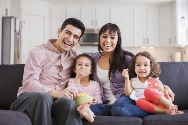 Family smiling together on sofa