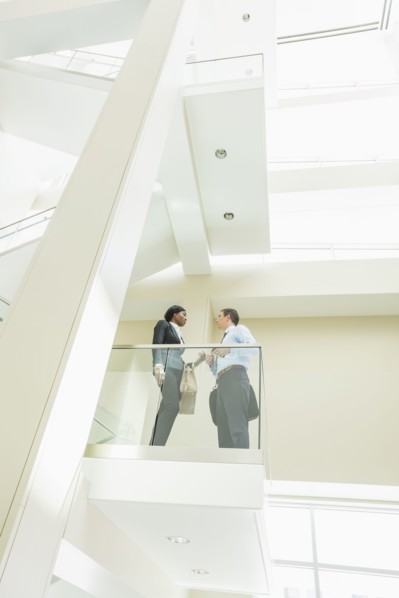 Low angle view of business people talking on office balcony
