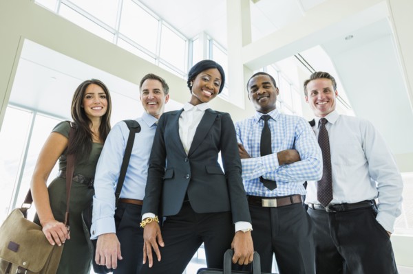 Low angle view of business people smiling in office lobby