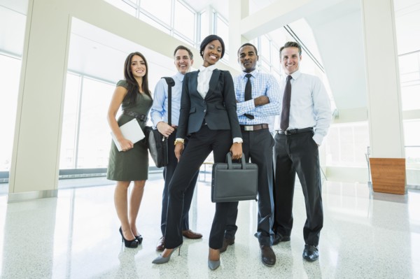 Business people smiling in office lobby