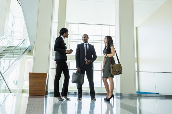 Business people talking in office hallway
