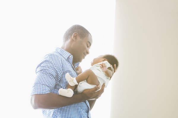 Father cradling baby son
