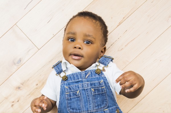 Black baby boy laying on floor