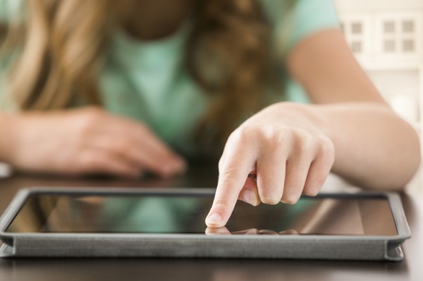 Close up of Caucasian girl using digital tablet