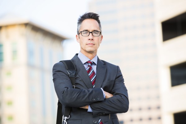 Mixed race businessman standing outdoors
