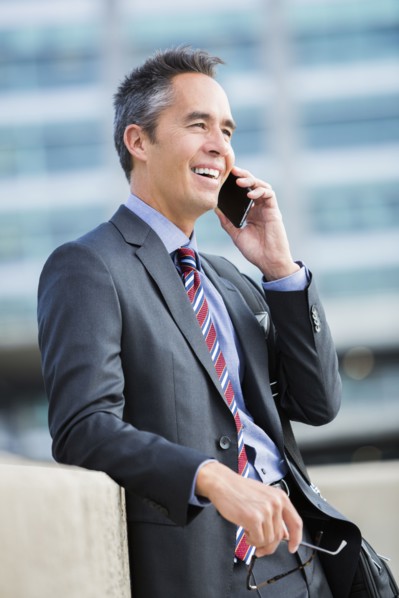 Mixed race businessman talking on cell phone