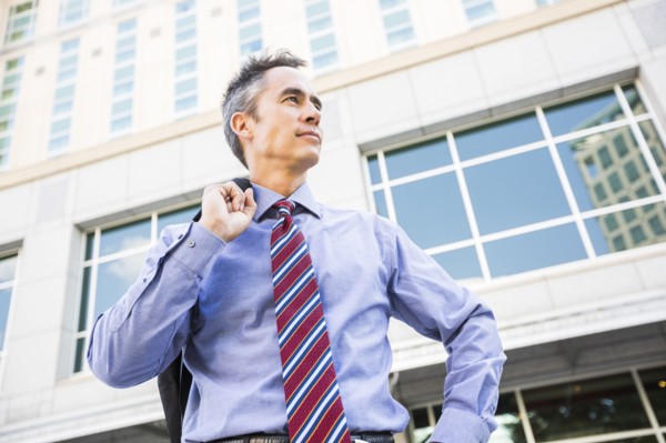 Mixed race businessman standing outdoors