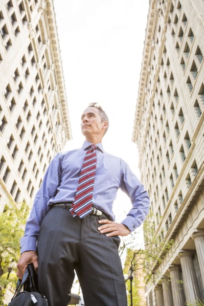 Mixed race businessman standing outdoors