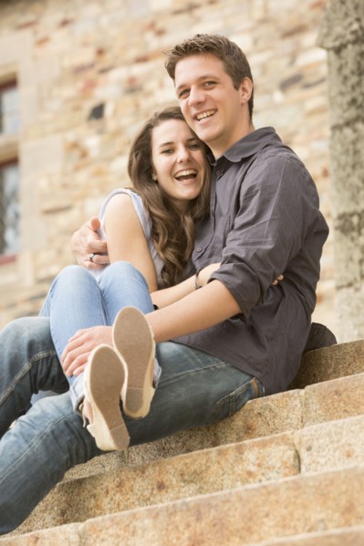 Caucasian couple sitting on castle steps