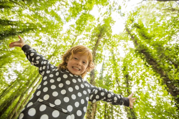 Caucasian girl standing in forest