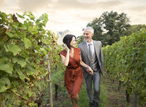 Caucasian couple walking in vineyard
