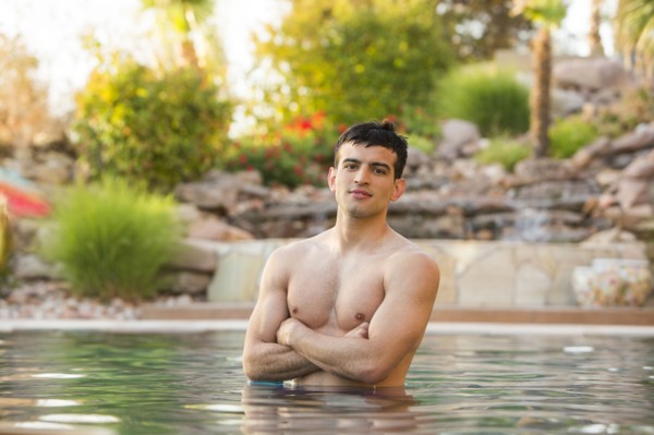Hispanic man standing in swimming pool
