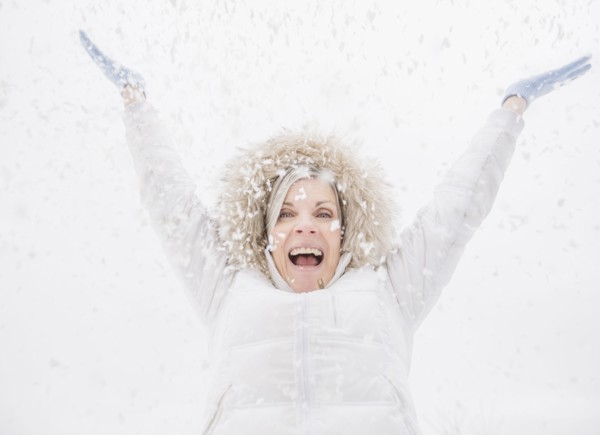 Caucasian woman playing in snow