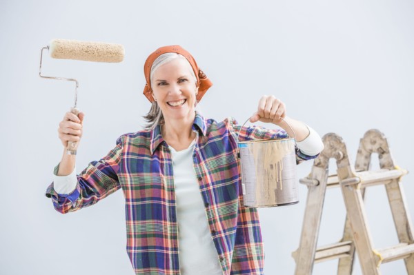 Caucasian woman painting in new home
