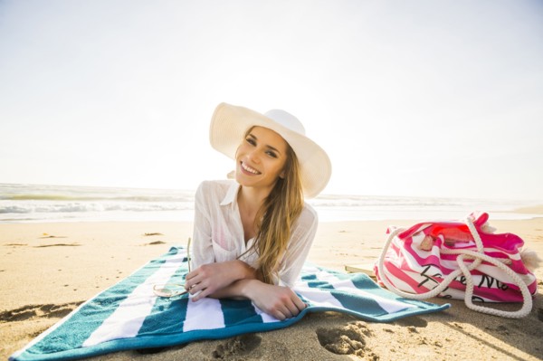 Caucasian woman laying on beach
