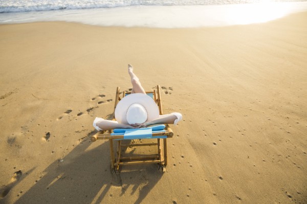 Caucasian woman laying on beach