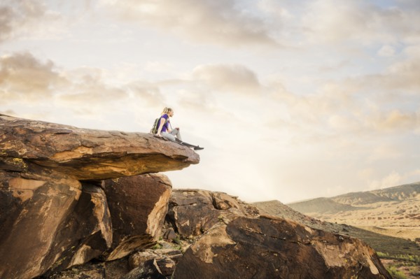 Caucasian woman sitting on rock formation