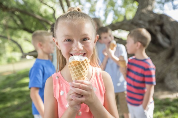 Caucasian girl eating ice cream cone