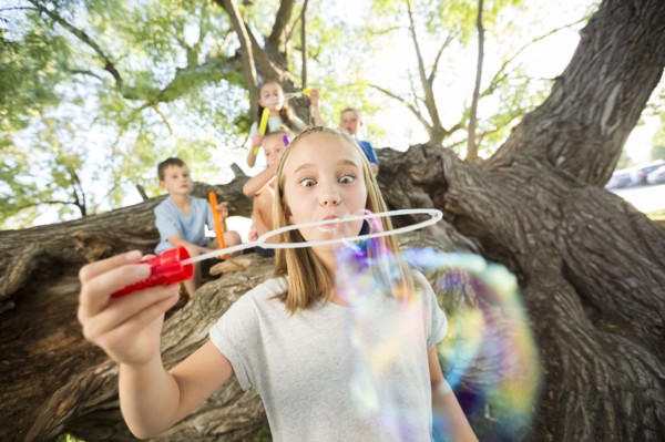 Caucasian girl making bubbles